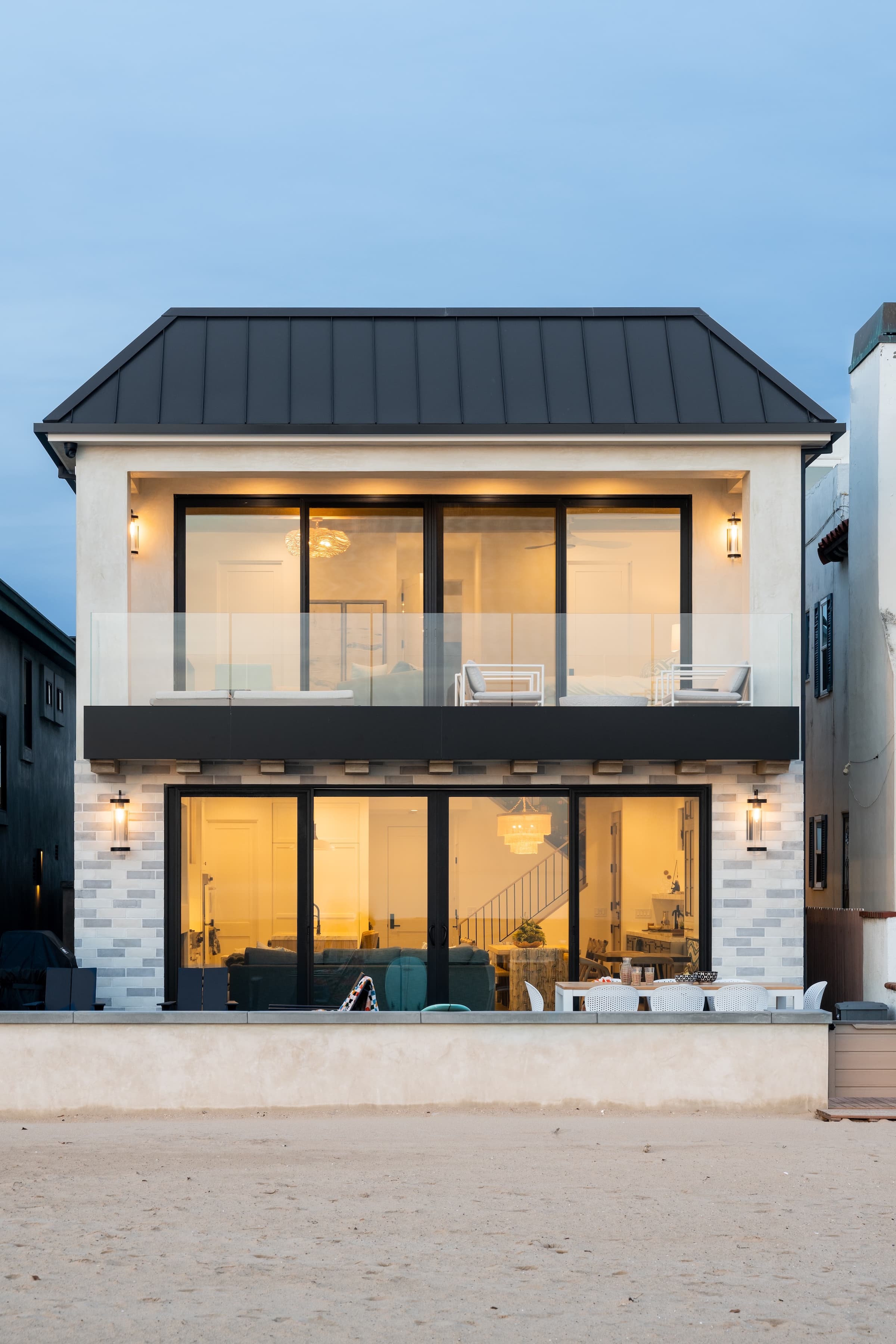 Custom oceanfront home exterior at dusk, Newport Beach